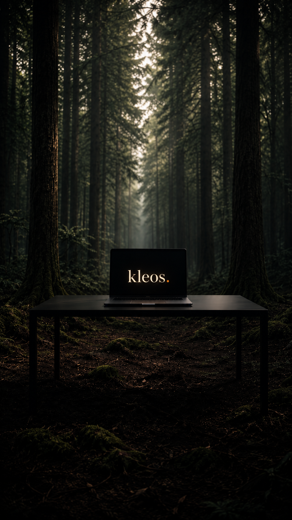 A laptop on a black table in a dark forest, its screen glowing with the kleos. wordmark.